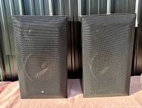 Pair of Braun L 8100 HE speakers with black metal front grilles visible.