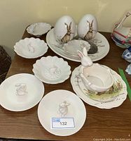 Overview of all Easter bunny dishes and decor items on wooden table