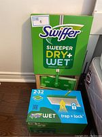 Photo showing two sealed boxes of Swiffer Wet Trap + Lock refills, each containing 32 wet cloths.