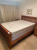 Front and side view of bed frame with mattress