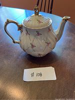 Image of Sadler England fine china teapot showing the overall shape, floral rose design, and gold trim.