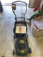 Full view of Yardworks electric lawn mower with handle and grass catcher bag.