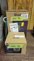 Front view of two Levoit boxes showing Core 300 Air Purifier and Pet Allergy Filter packaging with seller labeling.