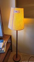 Floor lamp turned on showing shade texture and lamp proportions