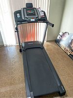 Front view of Healthrider H70T treadmill showing running belt and console.