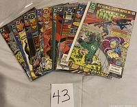 12 DC Comics fanned out showing diverse covers with Superman and other characters