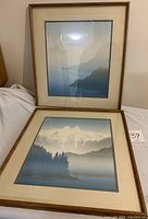 Two vintage framed Markgraf art pictures showing misty mountain and lake landscapes with soft gradients of blue and gray.