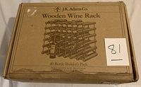 Front view of original J.K. Adams Co. box showing product name, 40 Bottle Builder's Pack, and a sketch of assembled wooden wine rack for 40 bottles. Box shows wear and slight water damage.