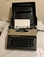Full view of the Sears portable typewriter with paper loaded and keyboard visible.
