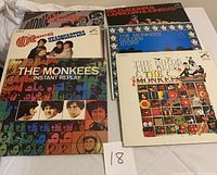 Box of assorted Japanese pressed vinyl records with The Monkees and Mamas and Papas album covers