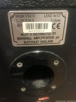 Close-up of the rear label on the cabinet showing model VS412, 140W RMS, 8 ohms, made and distributed by Marshall Amplification plc, Bletchley England.
