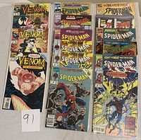Top view of all 15 comics including 3 Venom and 12 Spider-Man issues showing colorful front covers and condition.