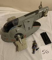 Slave 1 ship assembled with Boba Fett figure, blaster pistol, and Han Solo in Carbonite panel displayed