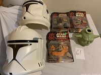 Two Episode 2 clone trooper helmets, Yoda head drink container, three packaged Space Wars toys