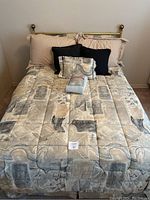 Full view of double bed made up with comforter, multiple pillows, metal headboard visible