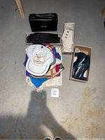 Overall photo showing various black and white gloves, handbags, scarves, hats, and the heels.