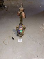 Full view of vintage Majolica table lamp from front showing ceramic base and twin bulb sockets.