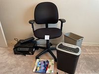Overview photo showing chair, printer, shredder, printer accessories and power bar