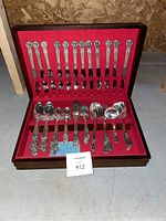 Full set of silverplate flatware including forks, spoons, with box interior in red lining