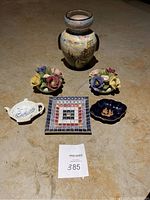 Full lot showing ceramic vase, two flower-shaped candle holders, and three small plates arranged together on floor.