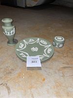 Set of three Wedgwood jasperware items showing plate, vase, and trinket box from front angle