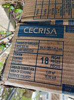 Close-up of box label showing size 295 x 295 x 6.2 mm, 18 pieces, covering area 1.57 m²