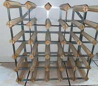 Front view of wine rack showing pine wood supports and stainless steel frame in a grid pattern.