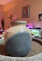 Side angle of 7-inch ceramic vase showing matte gray-blue glaze on natural tan body