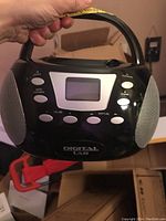 Front view of a black Digital Lab portable CD player showing display screen, control buttons, and speakers on sides.