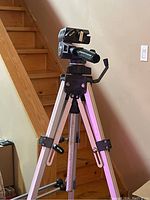 Full view of Slik 88N tripod with legs extended and photographic head with quick release plate attached, showing metal and plastic components, adjustment handle, and leg locks.