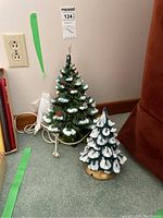Both ceramic Christmas trees side by side on floor