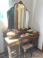 Full view of vintage vanity dresser with attached mirror and items on top