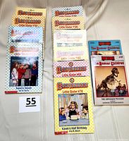 Ten Babysitter Little Sisters paperback books with visible numbers and titles, plus two Boxcar Children books on the right side.