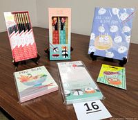 Full overview of the unopened sushi-themed desktop accessories collection showing pencils, pens, notepads, sticky notes with sushi illustrations