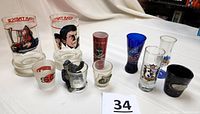 Wide shot of all 10 shot glasses displayed together showing variety and detail