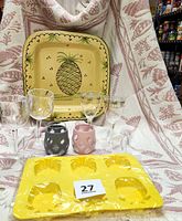Overall photo showing all items with platter, throw, stemware, glassware, and silicone mold displayed on pink and white themed cloth