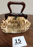 Front view of vintage chenille tapestry carpet bag purse with Bakelite handle and top