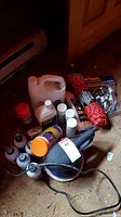 Photo of the electric polisher, cleaning bottles, orange utility rope, and other items arrayed on a floor.