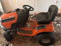 Side view showing overall condition, missing mower deck and front left flat tire