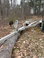 Overall view of aluminum boat trailer frame on forest floor