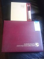 Lumio book-light box and Reader's Digest collection case side by side on black surface