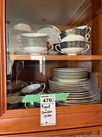 Top cabinet shelf showing double-handled soup bowls and stack of plates