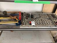 Overview shelf view of the saws and mallet alongside the socket set