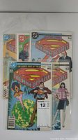 Five Superman The Man of Steel comic books stacked and visible through protective sleeves.