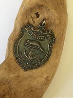 Front view of sterling silver beaver fob pendant with 'Vancouver, B.C.' inscription, showing beaver, maple leaf, and lettering.