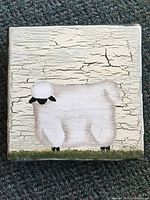 Top view of the wooden box lid showing hand painted sheep with crackled paint finish.