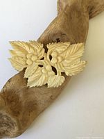 Front view of the large vintage natural hand carved brooch showing leaf and berry design.