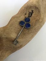 Top side of the vintage key pendant showing three round sodalite stones set in sterling silver.