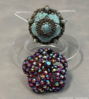 Close-up of the two vintage brooches, including details of stones and metalwork.