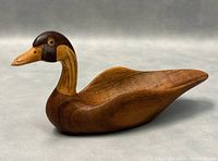 Side angle showing the duck bowl's profile, carved details on beak, neck, and body.